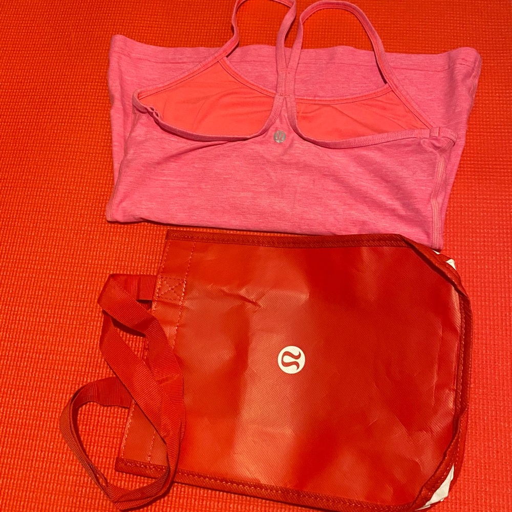 Lululemon pink tank top size 6 paired with a red tote bag Stylish and versatile.